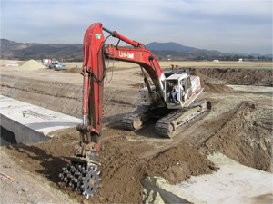 Excavator with ACE compaction wheel